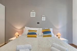 a bedroom with a large bed with two lamps at Adriatic Apartments Fažana in Fažana