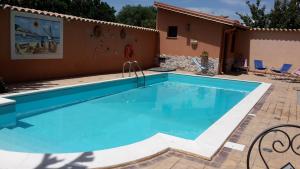 a swimming pool in front of a house at Villa Salvatore in San Leone