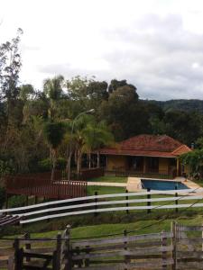 una casa con una recinzione davanti di Sítio da Dinda - Campos do Jordão a Rosas