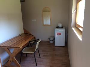 a small room with a wooden table and a small refrigerator at Bluszcz in Władysławowo