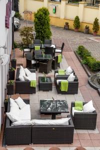 an outdoor patio with couches and tables and chairs at The Rooms by Dalia in Košice