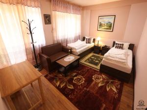 a living room with a bed and a couch at Aarya Chaitya Inn in Kathmandu