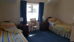 Postelja oz. postelje v sobi nastanitve Fairgreen Cottages