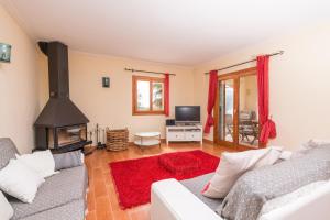 a living room with a couch and a fireplace at Can Canals in Artá