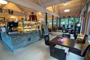 a restaurant with a counter and tables and chairs at Briksdalsbre Fjellstove in Briksdalsbre