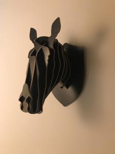 a black animal shaped object hanging on a wall at Chic & Basic Zoo in Barcelona