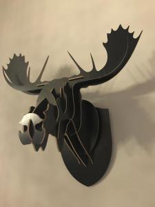 a wall mounted moose skull clock on a wall at Chic & Basic Zoo in Barcelona