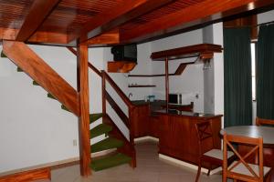 a wooden staircase in a room with a desk at Recanto das Aguas Quentes in Rio Quente