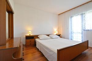 Posteľ alebo postele v izbe v ubytovaní Apartmani Šime