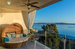 a balcony with a chair and a view of the water at Larimar Penthouse in Crikvenica
