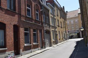 an empty alley in an old brick building at Apartment Aurora in Ieper