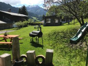 a backyard with a grill and a slide at MyApart 1709 in Jochberg
