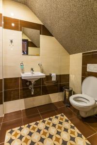 a bathroom with a toilet and a sink at Penzion Škorpión in Senec