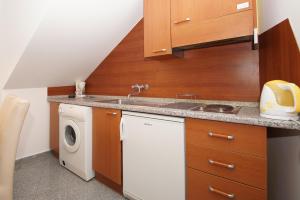a kitchen with a sink and a washing machine at Apartments Galerija in Korčula +44 photos