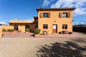 a large house with a patio in front of it at Apartamento El Pepito in Granollers