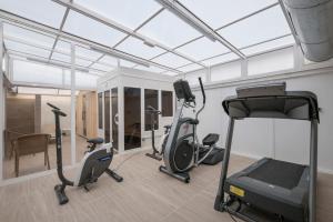 a gym with three exercise bikes in a room at Rosamar Maritim 4* in Lloret de Mar