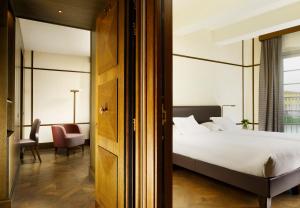 a hotel room with a bed and a chair at Hotel Balestri - WTB Hotels in Florence