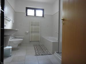 a bathroom with a tub and a toilet and a sink at B&B Masseria del Marchese in Castellana Grotte