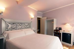 Postel nebo postele na pokoji v ubytování Hostal Los Castañuelos