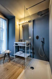 a bathroom with a glass shower and a sink at La casa dei colombi in Ruvo di Puglia