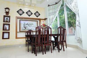 a dining room with a table and chairs and a window at Sea View Villa in Long Hai