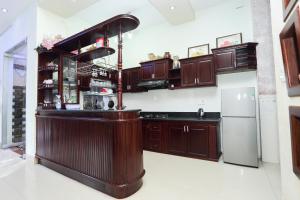 a kitchen with wooden cabinets and a bar at Sea View Villa in Long Hai