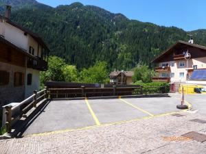 a parking lot in front of a mountain at Dolomiti Appartamento Ivano in Predazzo