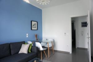 a living room with a couch and a table at KYMA Apartments - Athens Acropolis 7 in Athens