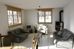 a living room with two couches and a tv at Residence Selika in Leuk