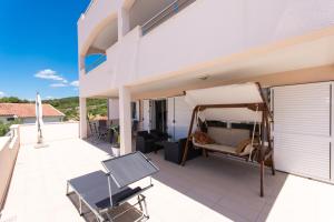 a balcony with a bed on the side of a house at Villa Anastasia in Trogir