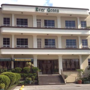 a large white building with a green sign on it at Ever Green Guatemala in Guatemala