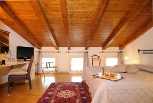 a bedroom with a bed and a table and a tv at La Dogana in Portogruaro