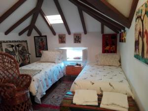 コインブラにあるAdore Portugal Coimbra Guest Houseのベッドルーム1室(ベッド2台、椅子付)