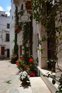 a street with flowers and a sign on a building at Santo Stefano in Putignano