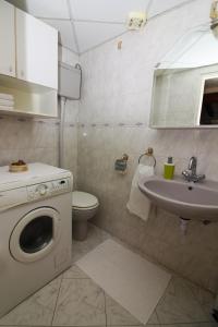 a bathroom with a washing machine and a sink at Princess Dora's Apartment in Dubrovnik