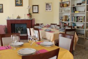 comedor con mesa, sillas y chimenea en Le Chiocciole, en Sannicandro di Bari