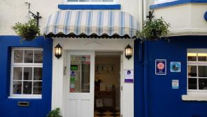 a blue and white building with a blue and white awning at Blands Cliff Lodge in Scarborough