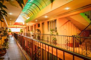 a building with a balcony with plants on it at Hotel Monserrat in Cochabamba