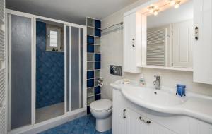 a bathroom with a toilet and a sink and a shower at Evita Apartments in Aliki