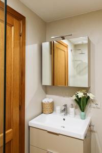 een badkamer met een wastafel en een spiegel bij Lora Center Room in Como