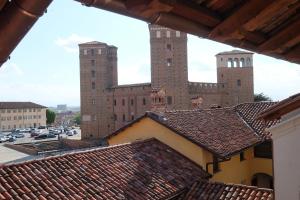 a view from the roof of a building with two towers at Palazzo Sacco Hostello Fossano in Fossano