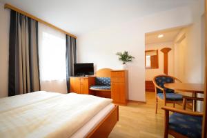 a hotel room with a bed and a table and chairs at Weststeirischer Hof in Bad Gams