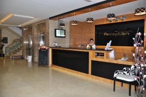 a reception area of a restaurant with two people at Hanem Hotel in Malatya