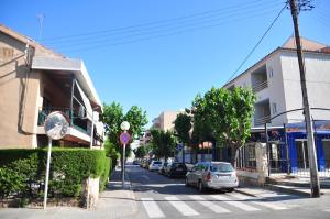 a street with cars parked on the side of the road at Hostal Porto Mar in Salou