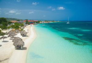 an aerial view of a beach with umbrellas and the ocean at Sandals Montego Bay All Inclusive - Couples Only in Montego Bay