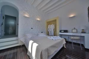 a bedroom with a bed with towels on it at AMO Folegandros in Karavostasi