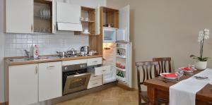 a kitchen with white appliances and a table with a table at Hotel Suite Home Prague in Prague +44 photos