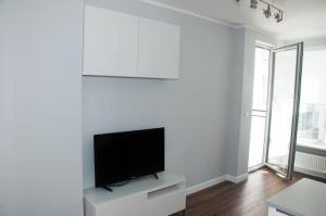 a living room with a flat screen tv on a white wall at Apartament Garazowa 5 in Warsaw