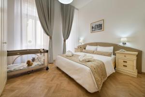 a bedroom with a bed with a crib in it at Hotel Suite Home Prague in Prague