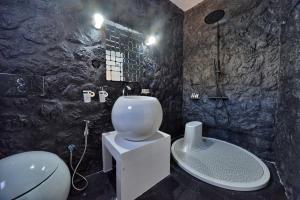 a bathroom with a shower and a toilet and a sink at AMO Folegandros in Karavostasi